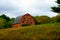 Historic, weathered old red barn on a hill