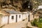 Historic whitewashed dewllings under cliff overhangs along the Rio Trejo