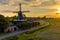 Historic windmill at a farm in agricultural landscape