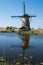 Historic windmill reflected in the water at Kinderdijk, Holland, Netherlands, a UNESCO World Heritage Site.