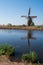 Historic windmill reflected in the water at Kinderdijk, Holland, Netherlands, a UNESCO World Heritage Site.