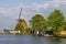Historic windmill by the river called Zwanburgermolen near Warmond, Netherlands