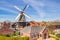 Historic windmill and typical dutch houses in Winsum