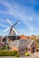 Historic windmill and typical dutch houses in Winsum