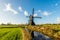 Historic wooden hollow post mill in a Dutch polder landscape