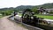 Historic wooden water wheel by irrigation canal and rice field in rural Japan