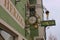 Historic wrought-iron guild sign in front of a clock store. Windischgarsten, Austria.