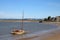 Historic yacht by beach on River Kent, Arnside.