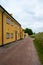 Historic yellow buildings along a gravel road at Landskrona castle in southern Sweden