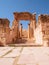 Historical archaeological site with gate and columns, ancient Roman structure in Jerash, Jordan.