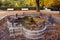 Historical beautiful fountain in old city park with bench in autumn