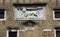 Historical brick facade with relief of winged lion