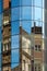 Historical buildings reflected in modern glass architecture