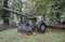 Historical cannon displayed in a green park next to a bench