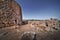 Historical castle near rock formations under the clear sky in Su Nuraxi, Sardinia, Italy