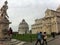 The historical center of Pisa. Architectural ensemble. Tourists are photographed at the monuments.