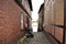 Historical cobblestone alley with half-timbered houses at a rainy day