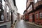 Historical cobblestone alley with half-timbered houses at a rainy day