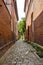 Historical cobblestone alley with red brick houses in the German medieval town Hitzacker