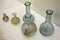 Historical laboratory glassware from 19th century, round bottom and florence flasks, also two kinds of thick stained small bottles