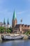 Historical ship and church along the river Weser in Bremen