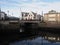 Historical square with bridge in european Alesund town reflected in water at Romsdal region in Norway