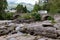 The historical stone bridge of A827 road above the river and falls of  Dochart in Killin, Scotland with a car with a caravan