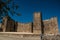 Historical stone defense fortress Castillo de Trujillo under a clear blue sky in Spain