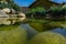 Historical village life landscape with lotus leaf, stones, reflection of adobe village house and lake from Izmir, Turkey