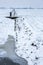 Historical windmills in a cold and snowy Dutch farmland.