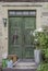 Historical wooden door, 2 leafy, with stone staircase, flower decoration and wrought iron fitting