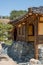 Historical wooden framed Korean building with wooden shakes roof built on stone foundation blue sky