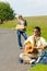 Hitch-hiking young couple backpack asphalt road