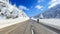 Hitchhiker man walking on snowy roads in winter season