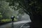 A hitchhiker standing in the rain, sheltered under a tree, emphasizing the determination of those on an autostop journey.