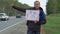 Hitchhiking Man Holding a Cardboard Sign