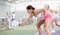 Hitting the ball with a racket. Pickleball game - woman with partners plays on tennis court