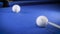 Hitting the cue ball number 7 on a blue billiard ball. The billiard ball hits the pocket