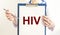 HIV acronym - Human Immunodeficiency Virus - word on paper in doctor hands as medical concept