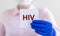 HIV acronym - Human Immunodeficiency Virus - word on paper in doctor hands as medical concept