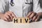 HIV acronym inscription on dices in doctor hands