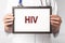 HIV acronym, inscription on paper in doctor hands