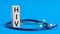 HIV word written on wooden blocks and stethoscope on light blue background