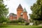Hjularod is a romantic red castle with tall towers situated in a green park