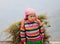 A Hmong girl carrying grass on the rural road at Sapa town, northern Vietnam