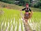 Hmong tribal Woman in black native dress with basket walking on ridge