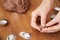 Hnads preparing Christmas cookies in the form of nuts from dough