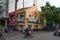 Ho Chi Minh city, Vietnam - December 2018: motorbikes on the crossroad of the city with yellow house and signs.