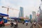 Ho Chi Minh city, Vietnam - December 2018: traffic near construction area in the city with people, motorbikes, skyscrapers, buses.