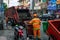 Ho Chi Minh, Vietnam - 17 Jul 2019: Professional clean staff cleaning garbage container. Street scene with trash cleaner